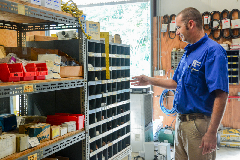 climate services staff member pulling parts